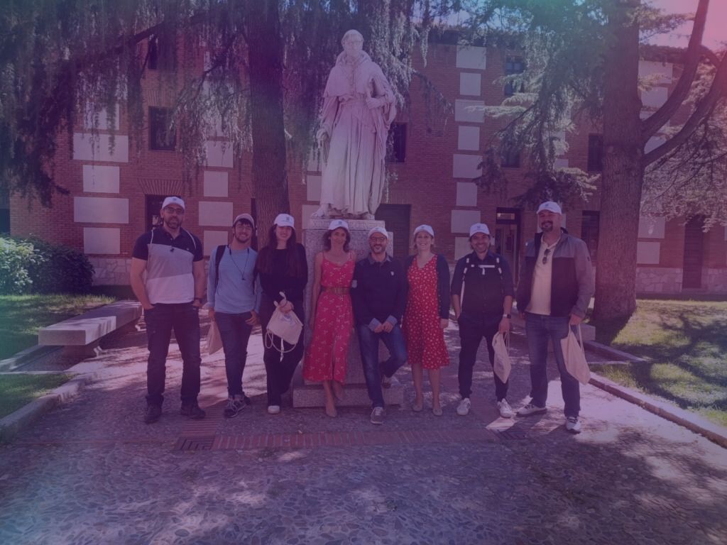 working group 7 members standing in front of a statue
